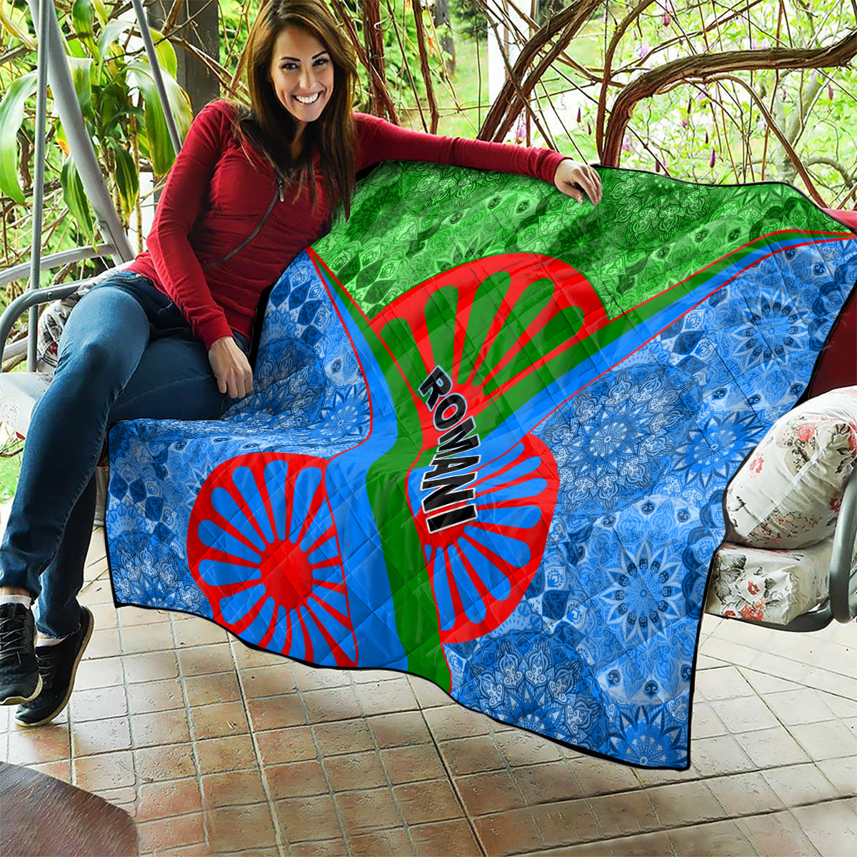 Romani pattern quilt with green top, blue sides, red Ro-man text and wheel graphic