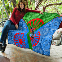 Romani pattern quilt with green top, blue sides, red Ro-man text and wheel graphic