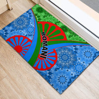 Rectangular rubber doormat with blue medallions, green center panel, red sunburst arcs, ROMANI text