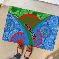 Rectangular rubber doormat with blue and green tribal medallions, red sunburst arcs, ROMANI logo