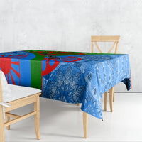 Blue patterned tablecloth draped over a table with matching multicolor border graphic