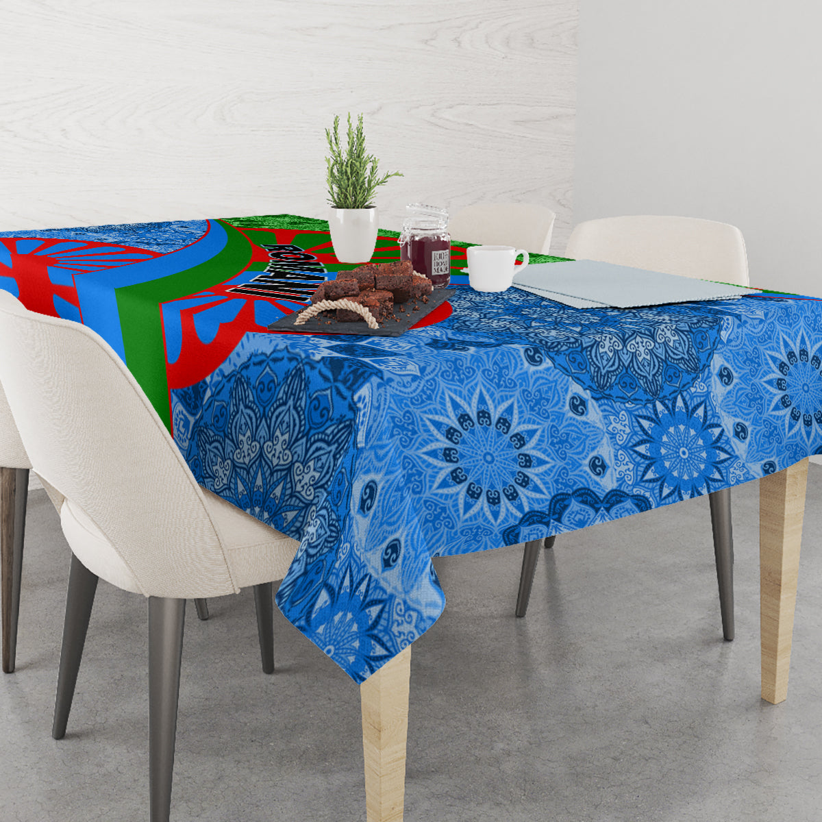 Blue and multicolor tablecloth with ornate floral motifs draped across a dining table