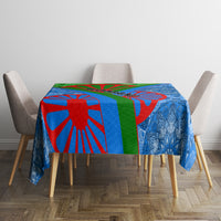 Blue tablecloth with red and green geometric stripes and ornate dark-blue floral pattern