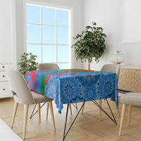 Blue patterned tablecloth on a dining table with multicolor geometric accents