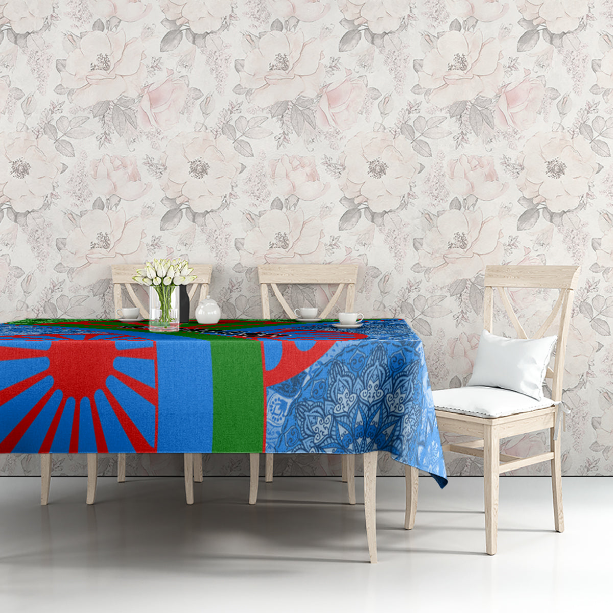 Blue and multicolor tablecloth with ornate floral print draped on a console table