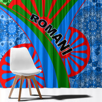 Blue and green window curtain close-up with red sunburst and bold diagonal tribal stripes.