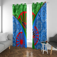 Blue window curtain panels with green top sections and red sunburst tribal artwork.