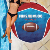 Round rugby beach blanket draped by two people, Turks and Caicos Islands football print and fringe