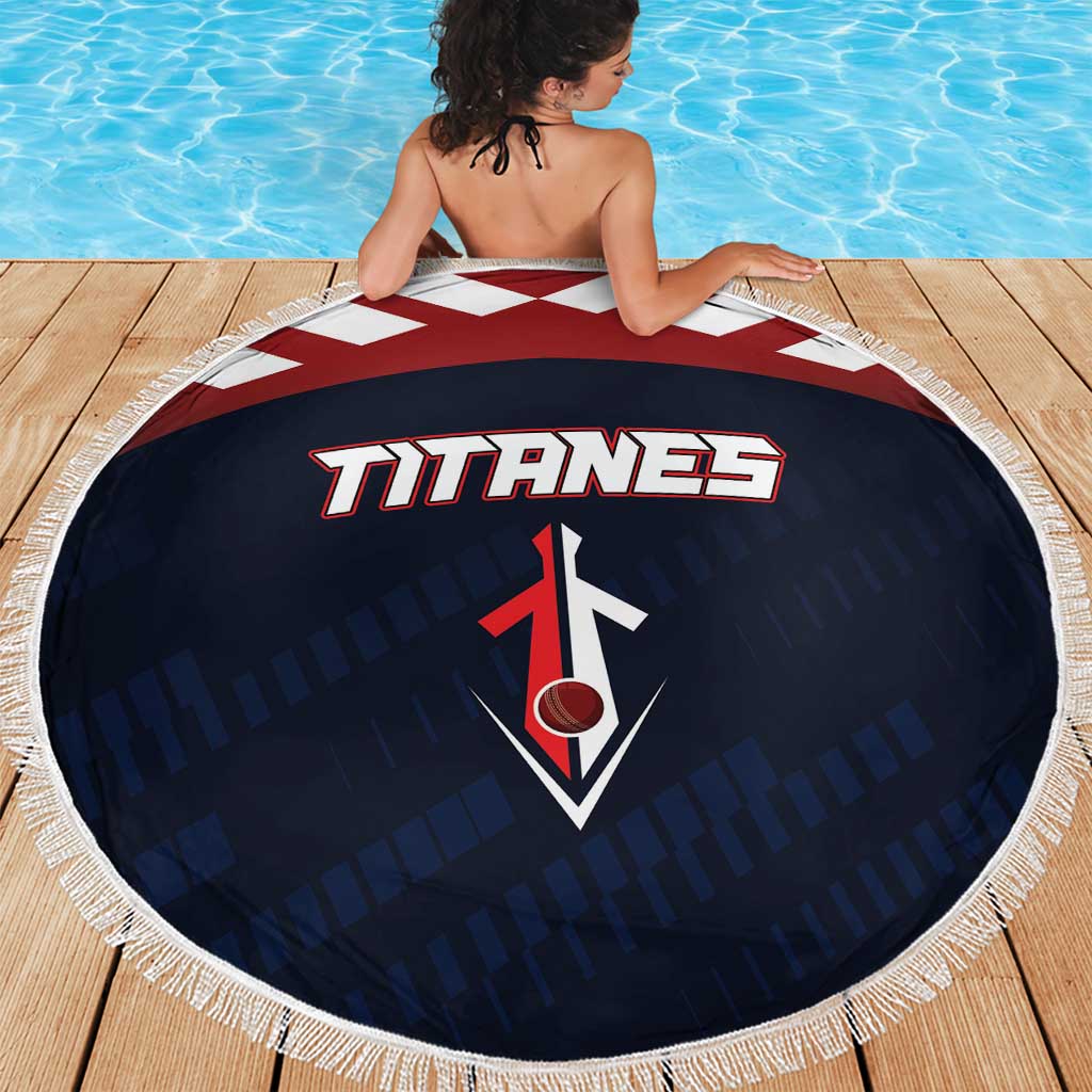 Round Titanes beach blanket with navy print, red-and-white logo, and white fringed edge