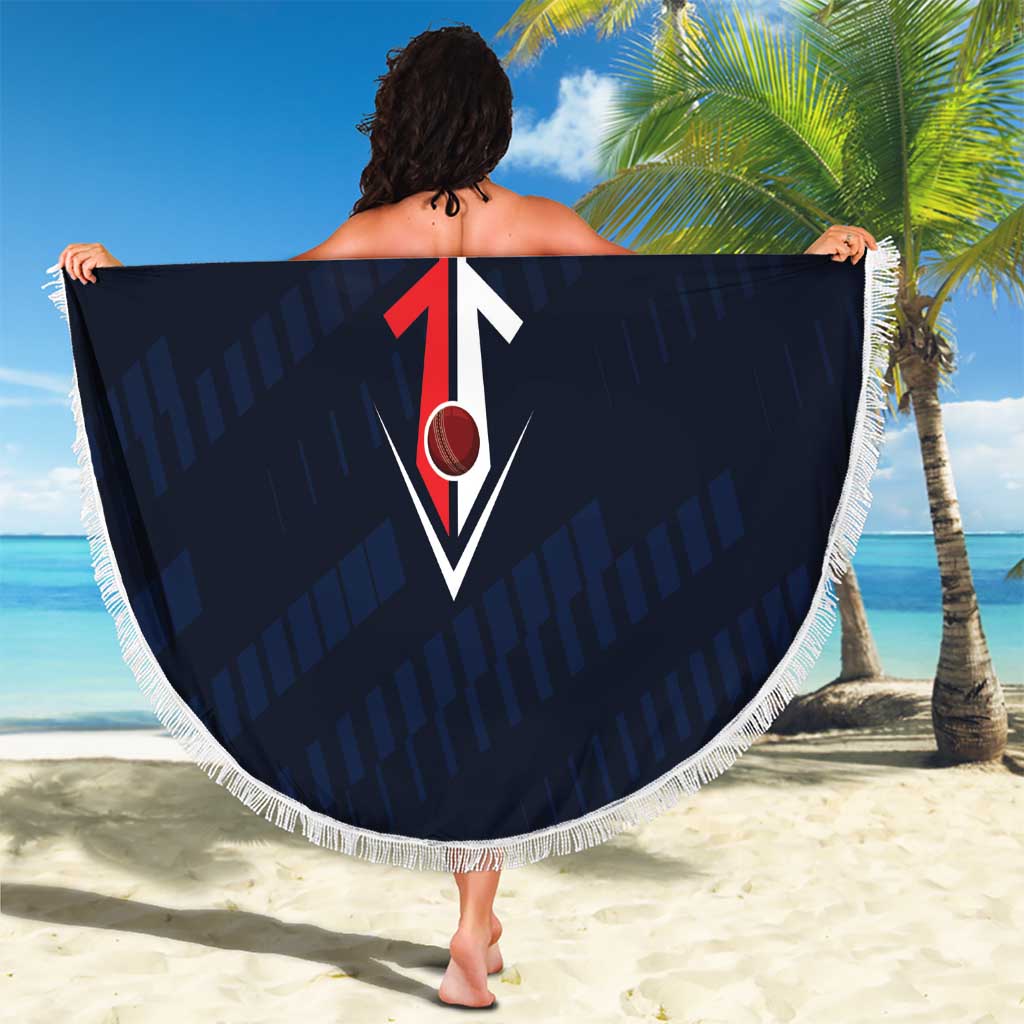 Round Titanes beach blanket held open, navy design with red diamond logo and white fringe