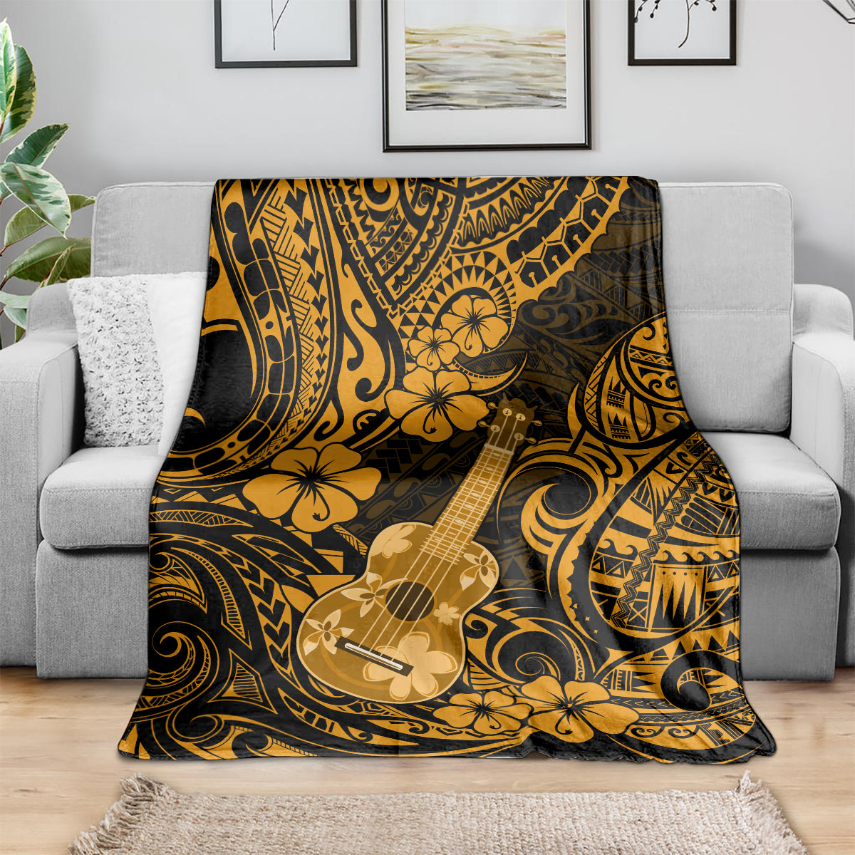 Folded Hawaiian ukulele blanket in gold and dark polynesian pattern with floral motifs