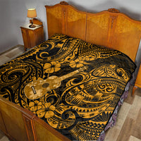 Gold and black ukulele print quilt laid on a bed with Polynesian scroll and flower designs