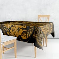 Black and gold polynesian tablecloth draped over rectangular table