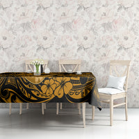 Black and gold polynesian tablecloth featuring floral tribal pattern on table