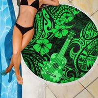 Green circular beach blanket with white fringe, Polynesian guitar and hibiscus print.