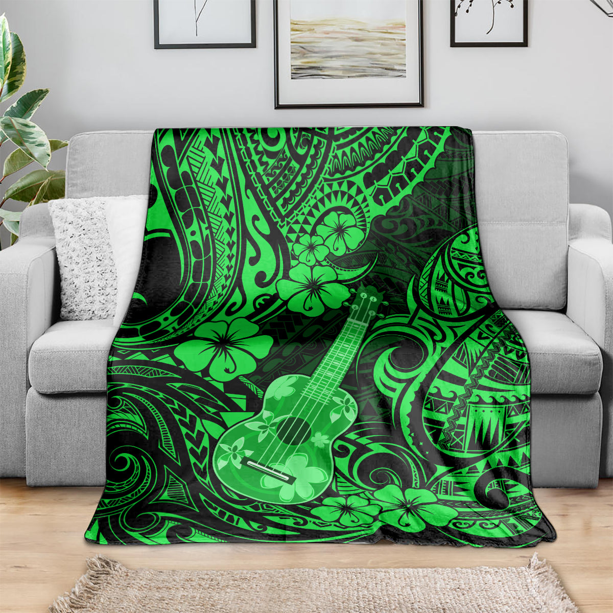 Green ukulele blanket with Polynesian tribal swirls and flower motif, draped on sofa