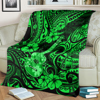 Green ukulele blanket with Polynesian floral pattern, draped over sofa