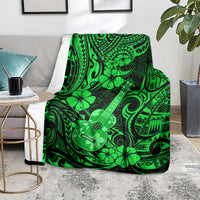 Green ukulele blanket with Polynesian floral pattern, draped on armchair