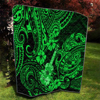 Green Polynesian ukulele and clover quilt blanket with black border, quilted texture
