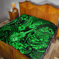 Green Polynesian pattern quilt blanket with ukulele and clover motifs on bed