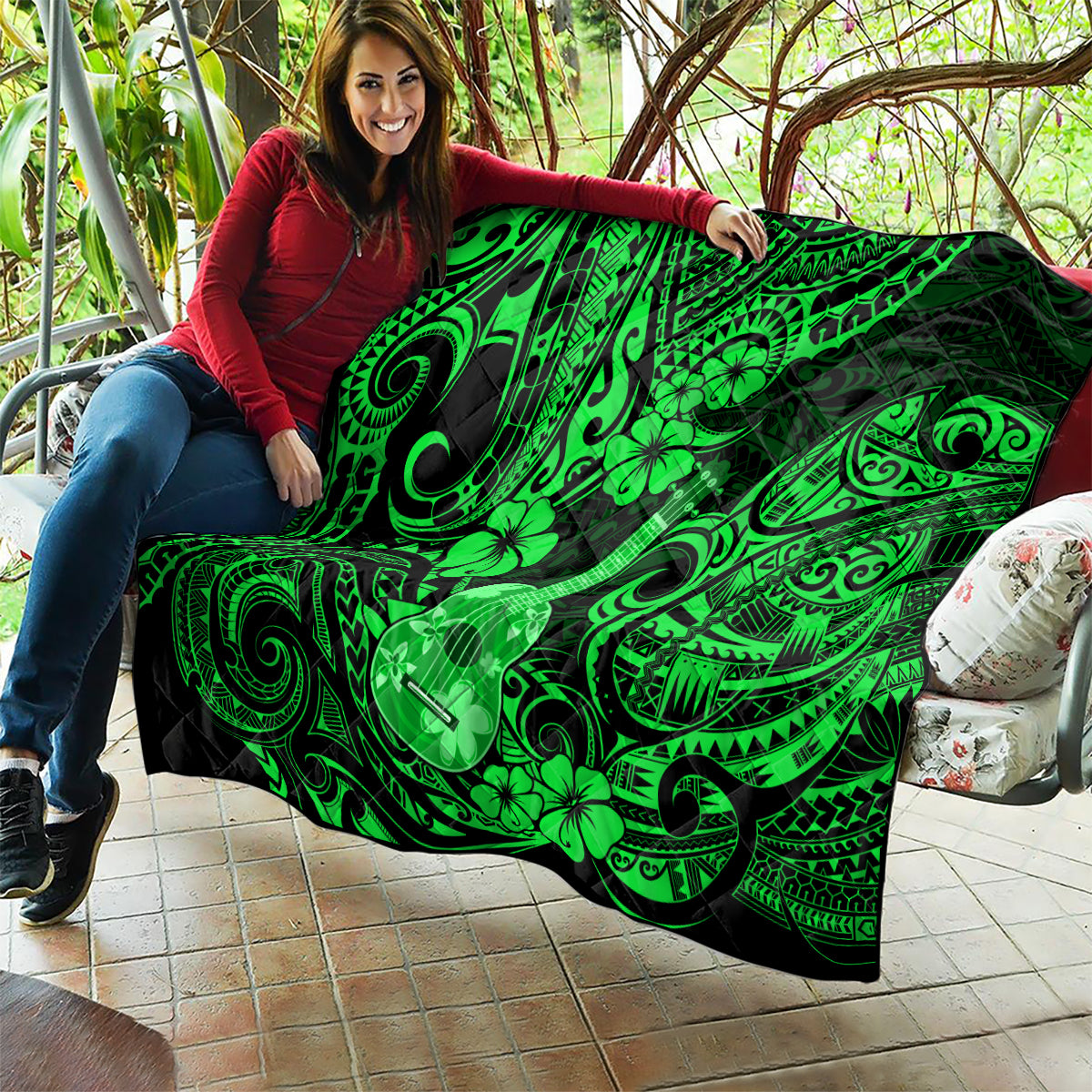 Green Polynesian ukulele and clover quilt blanket held up on couch cushions