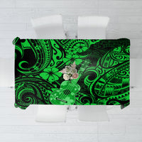Green Polynesian-pattern tablecloth with black accents and hibiscus and ukulele motif