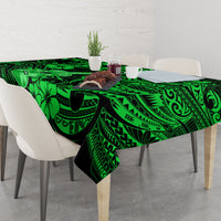 Green Polynesian-pattern tablecloth covering dining table with bold tropical graphics
