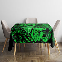 Green Polynesian-pattern tablecloth on square table with matching hibiscus and swirl design