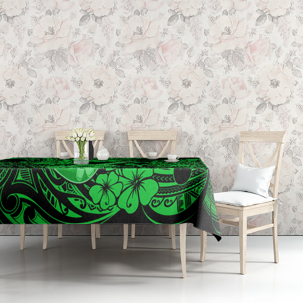 Green Polynesian-pattern tablecloth with hibiscus and ukulele motifs across dining table
