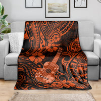 Orange and black ukulele-themed Polynesian patterned throw blanket on a couch