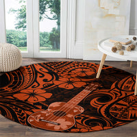 Round orange and black Polynesian pattern rug featuring ukulele and tribal shapes