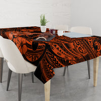 Orange and black Polynesian patterned tablecloth on dining table with chairs