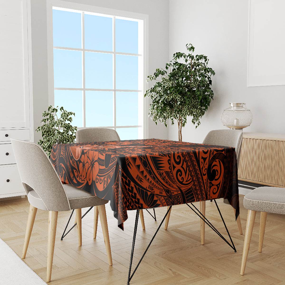 Orange and black Polynesian pattern tablecloth on dining table with four chairs