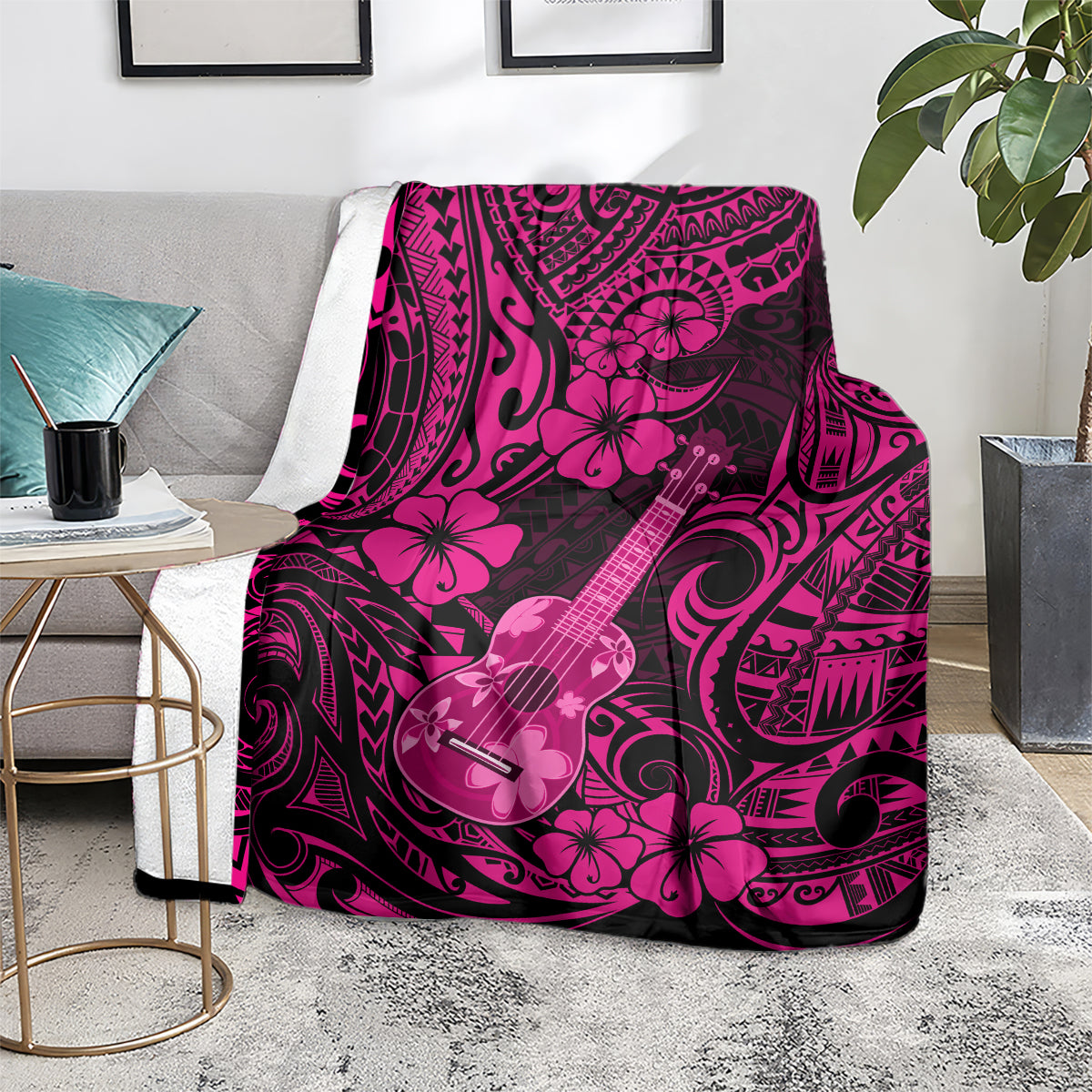 Pink polynesian ukulele blanket with hibiscus and ukulele design, on chair