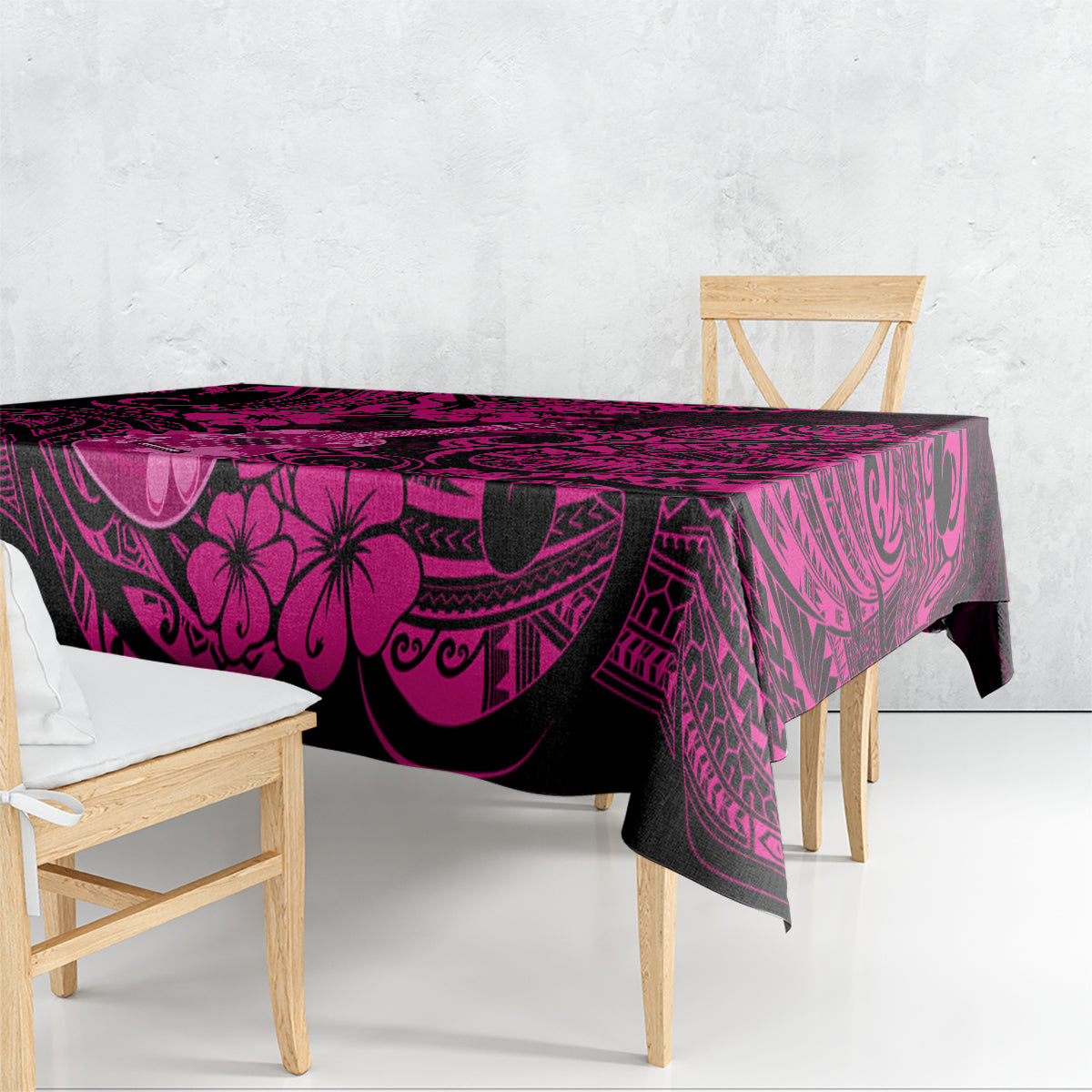 Pink and dark Polynesian patterned tablecloth draped over a rectangular table