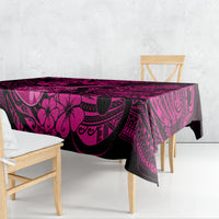 Pink and dark Polynesian patterned tablecloth draped over a rectangular table
