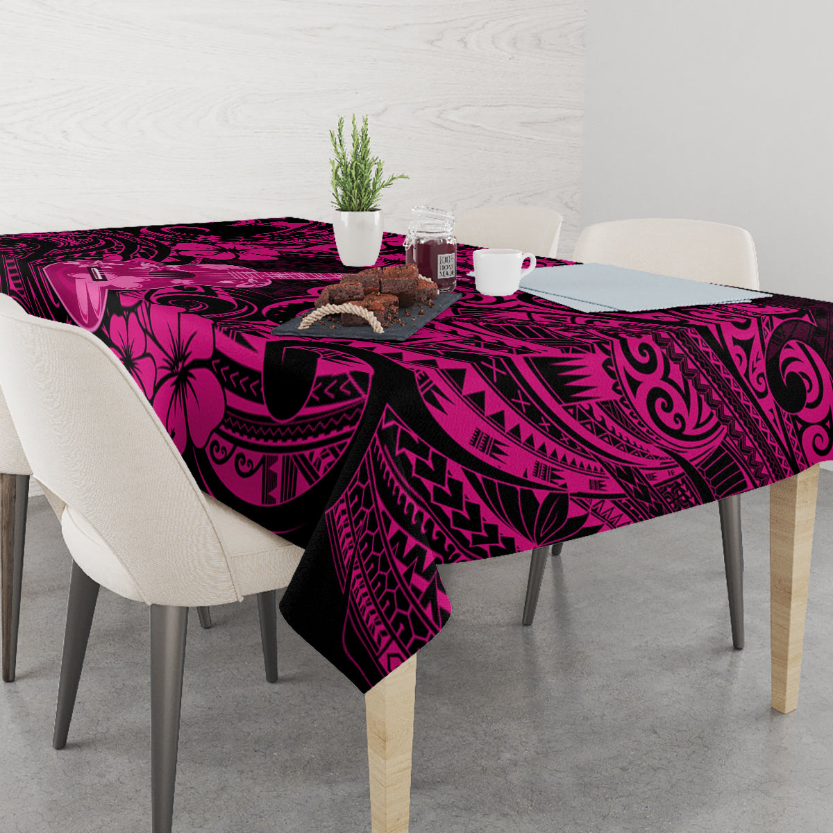 Pink and dark hibiscus and swirl tablecloth covering a dining table, overhanging edges
