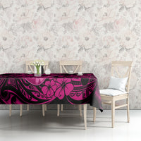 Pink and dark hibiscus swirl tablecloth on a long table, scalloped overhang edges