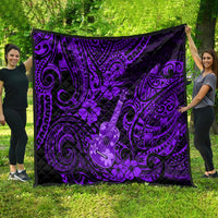 Purple Polynesian ukulele quilt spread on grass, black backing and ornate swirls