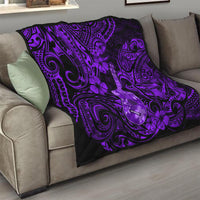 Purple Polynesian ukulele quilt folded on gray sofa, black edge and swirling pattern