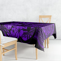 Purple Polynesian tablecloth with black island motifs, draped over dining table