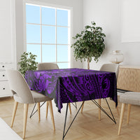 Purple Polynesian tablecloth with black swirls, covering dining table centerpiece