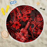 Round red-and-black Polynesian pattern beach blanket with fringe edge