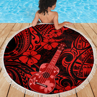 Round Polynesian pattern beach blanket in red and black on wooden deck, fringe edge