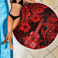 Round red-and-black beach blanket with floral ukulele motif and white fringe edge