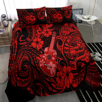 Red and black Polynesian comforter and pillowcases with guitar, flowers, and tribal motifs