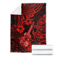 Red Hawaii ukulele blanket folded with white towels, polynesian red-and-black pattern