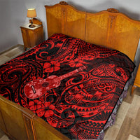 Red and black Polynesian quilt on a bed, with ukulele graphic and hibiscus-like flowers