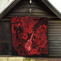 Red and black Polynesian pattern quilt hanging on a wooden wall, ukulele and swirls