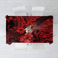 Red and black Polynesian-pattern tablecloth with ukulele print, folded flat